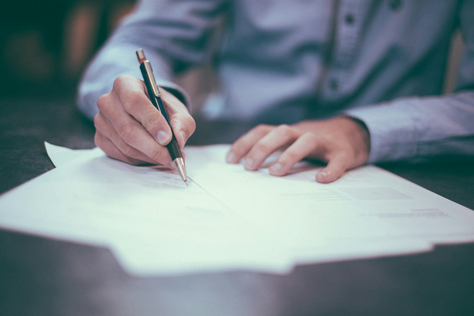 Documents being signed at a desk